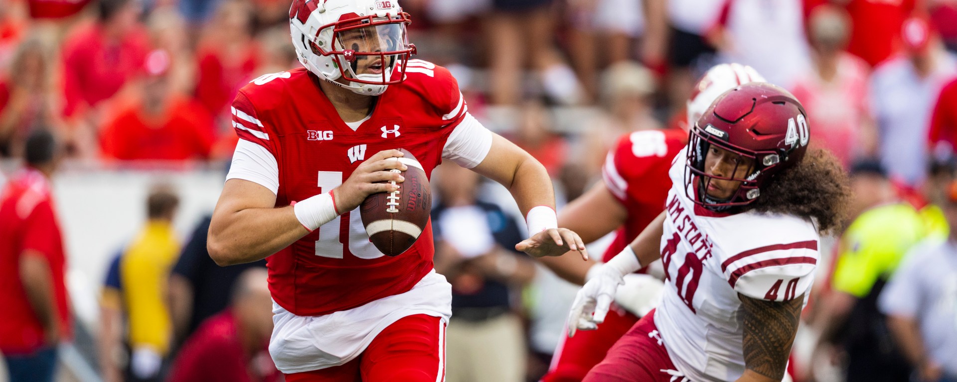Former Badger's quarterback Deacon Hill scrambling in a game against New Mexico State. Photo by Tom Lynn/Wisconsin Athletic Communications