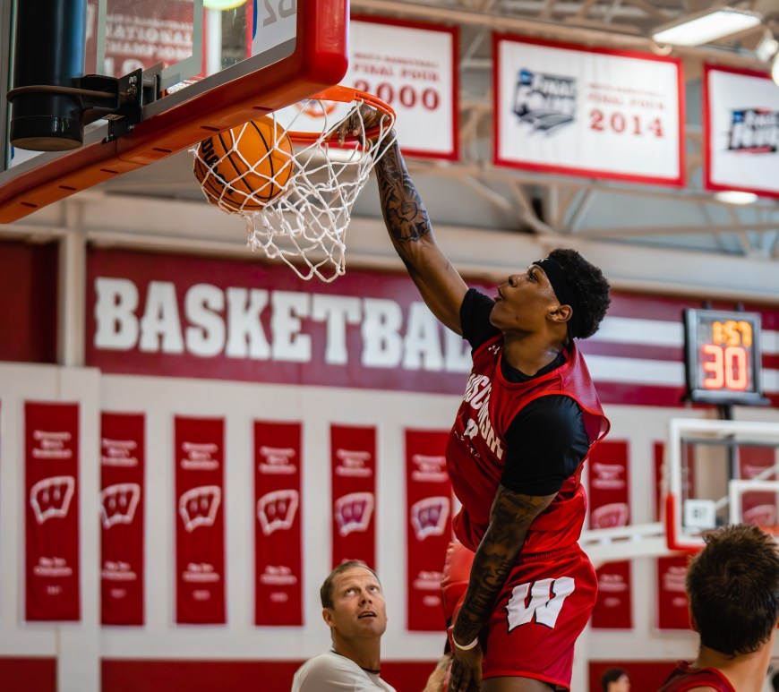 A photo of AJ Storr throwing down a one handed dunk in practice.