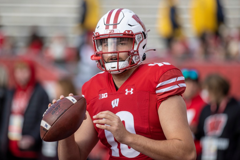 A photo of Deacon Hill playing quarterback for the Wisconsin Badgers.