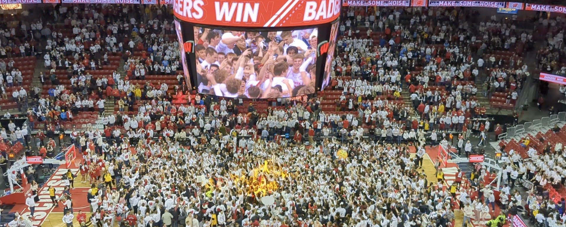 A photo of the students swarming the Kohl Center court.
