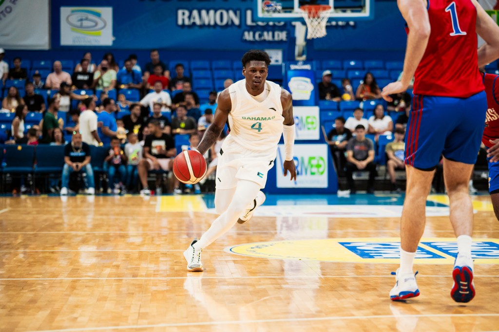 New Wisconsin Badger AJ Storr dribbling in a Bahamas national team jersey.