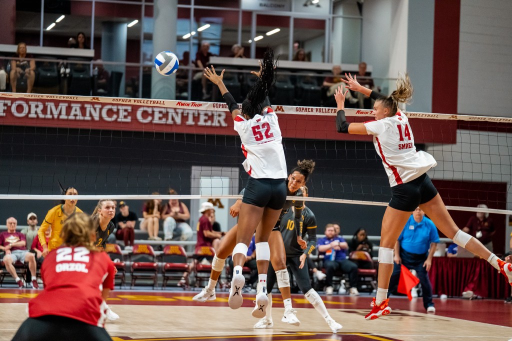 Anna Smrek and Carter Booth block a shot