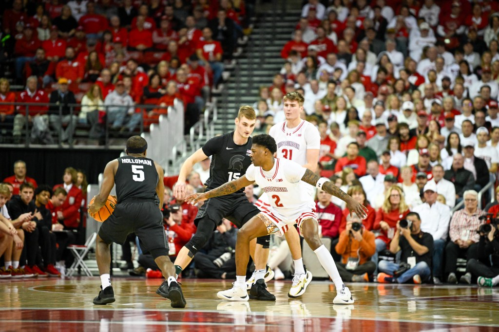 AJ Storr in a defensive position at the three point line.