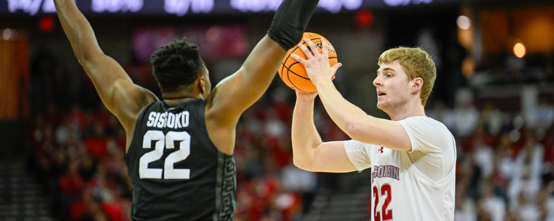 Steven Crowl looks for a pass while a Michigan State defender has his arms up.
