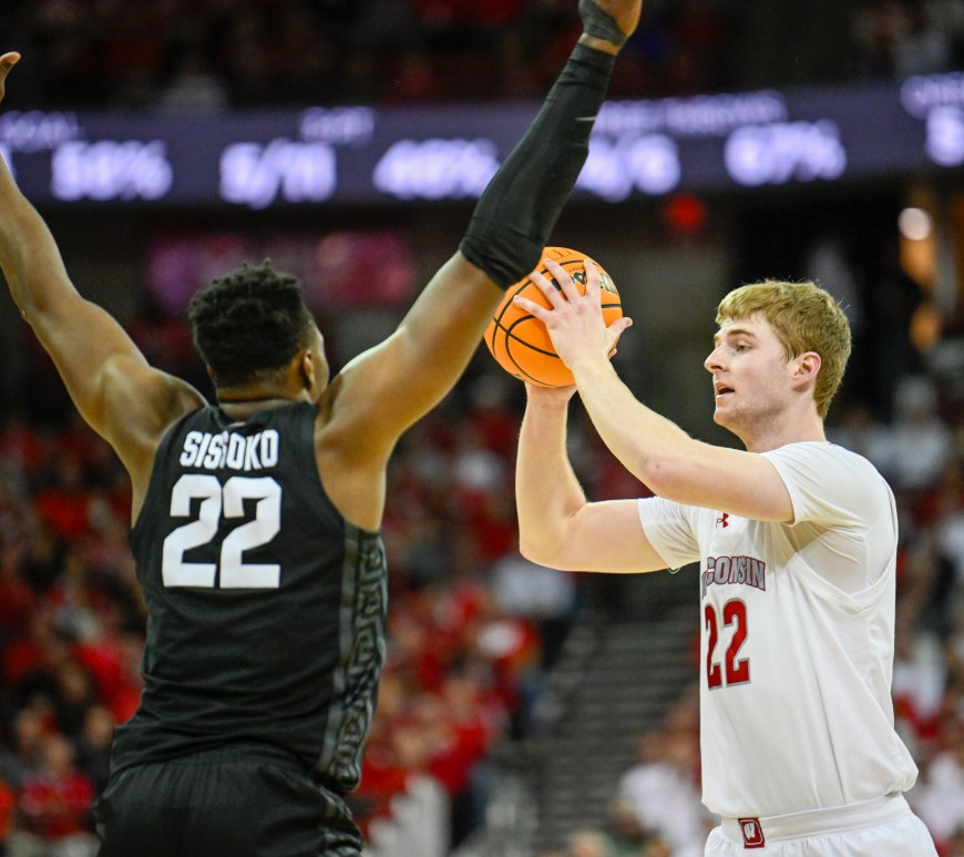 Steven Crowl looks for a pass while a Michigan State defender has his arms up.