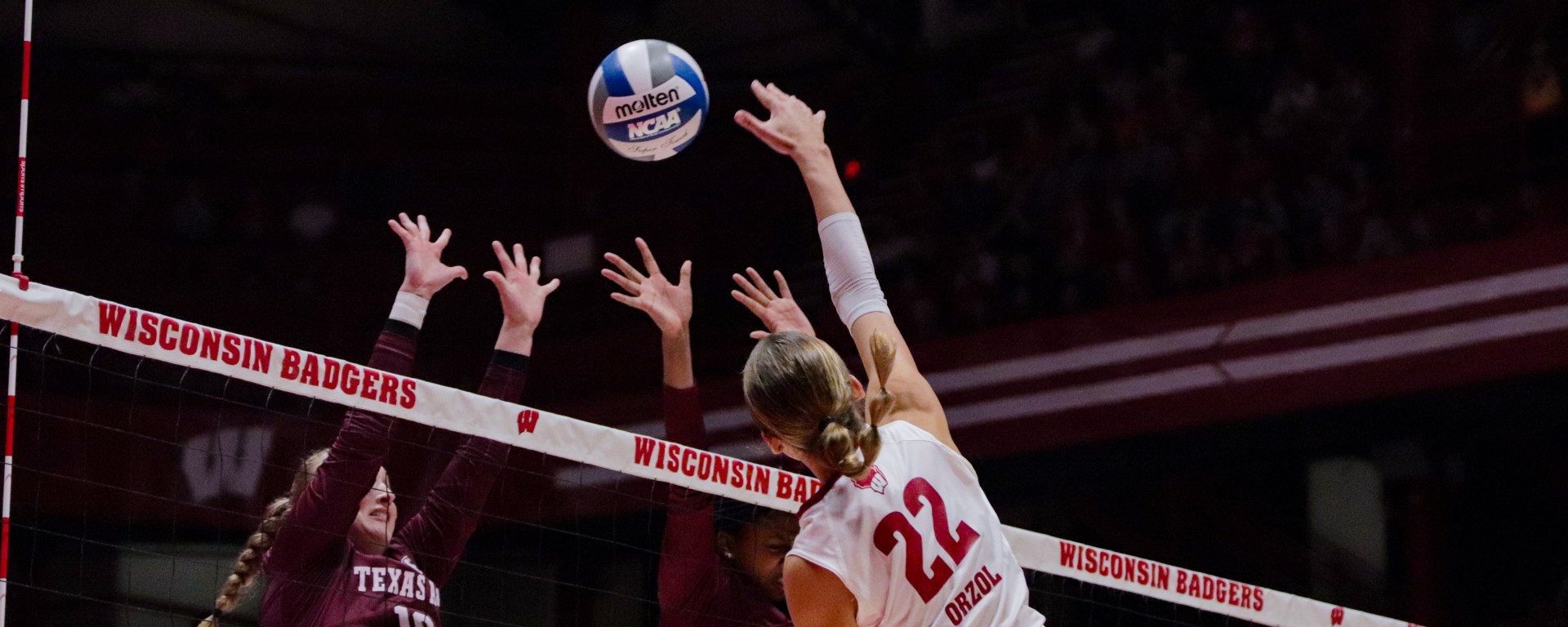 Julia Orzol hits the ball back at two Texas A&M defenders.