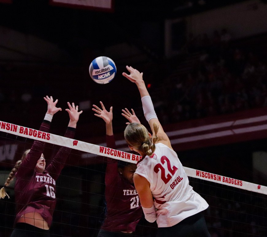 Julia Orzol hits the ball back at two Texas A&M defenders.