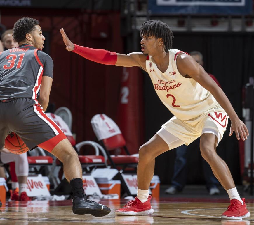 Aleem Ford holds his hand in an opponents face as he defends.